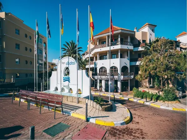 Parque Albatros resort entrance with flags and logo sign, Golf del Sur, Tenerife