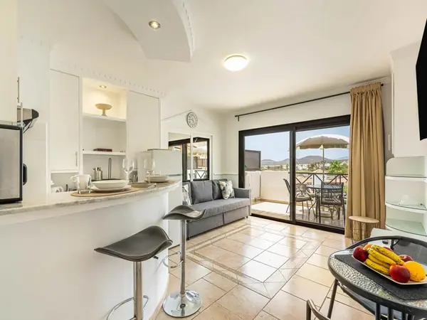 Modern apartment interior at Parque Albatros with open-plan kitchen, living area and balcony, Golf del Sur, Tenerife