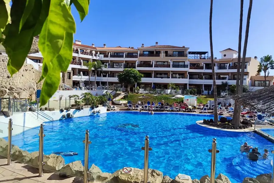 Parque Albatros resort pool with sun loungers and apartment buildings, Golf del Sur, Tenerife