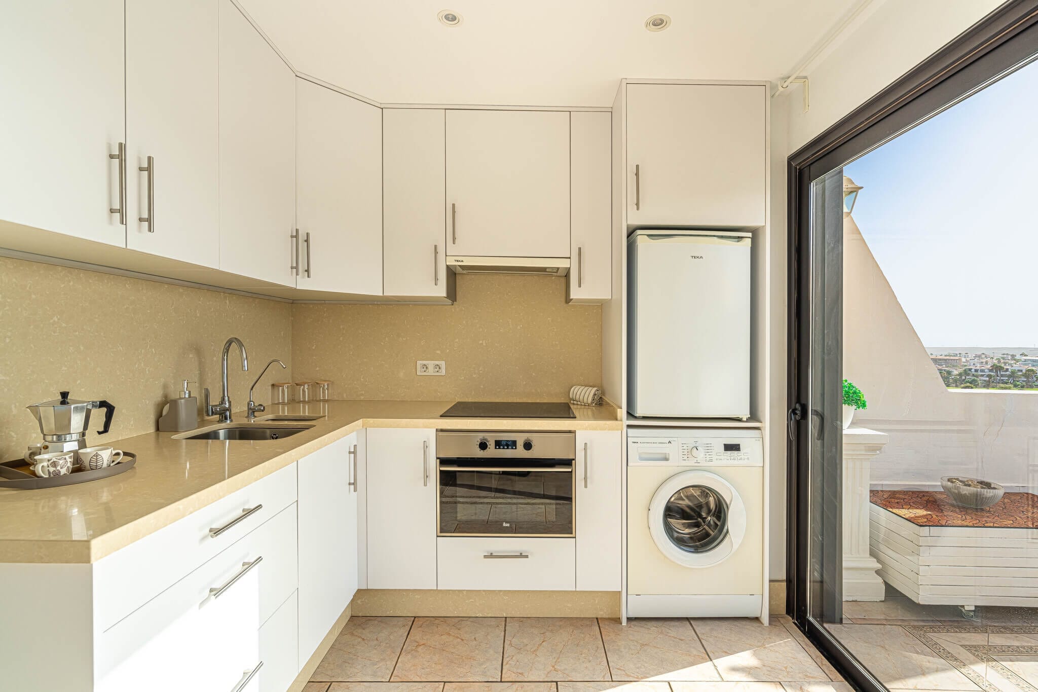 34 Modern kitchen with white cabinets and appliances.
