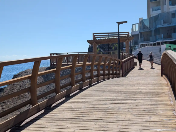 The wooden walkway section of the coastal promenade in Golf del Sur, with views of the Atlantic Ocean