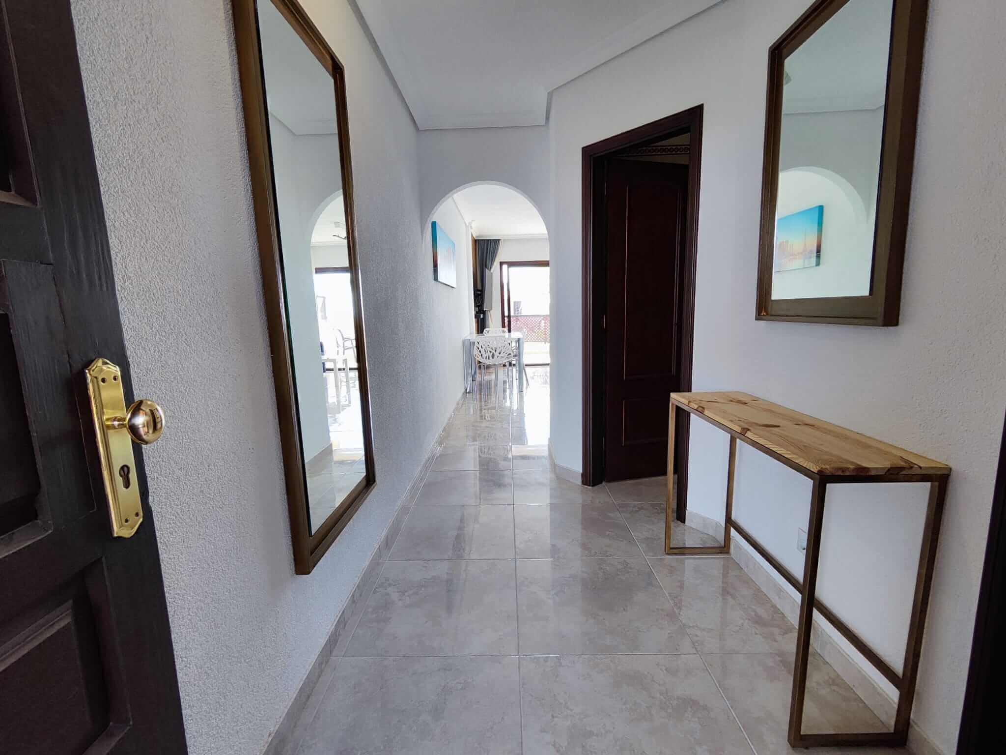 Modern hallway with mirrors and wooden console table