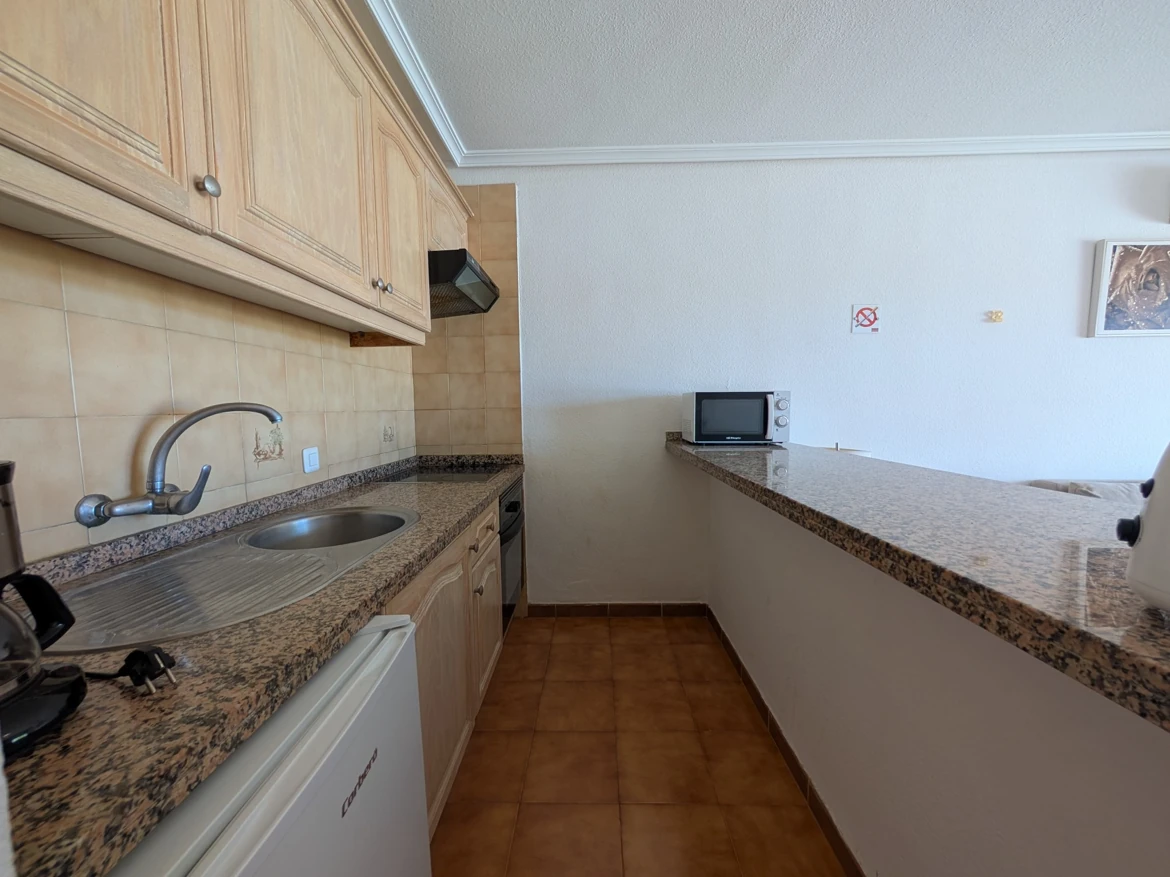 Modern kitchen with granite countertops and appliances.