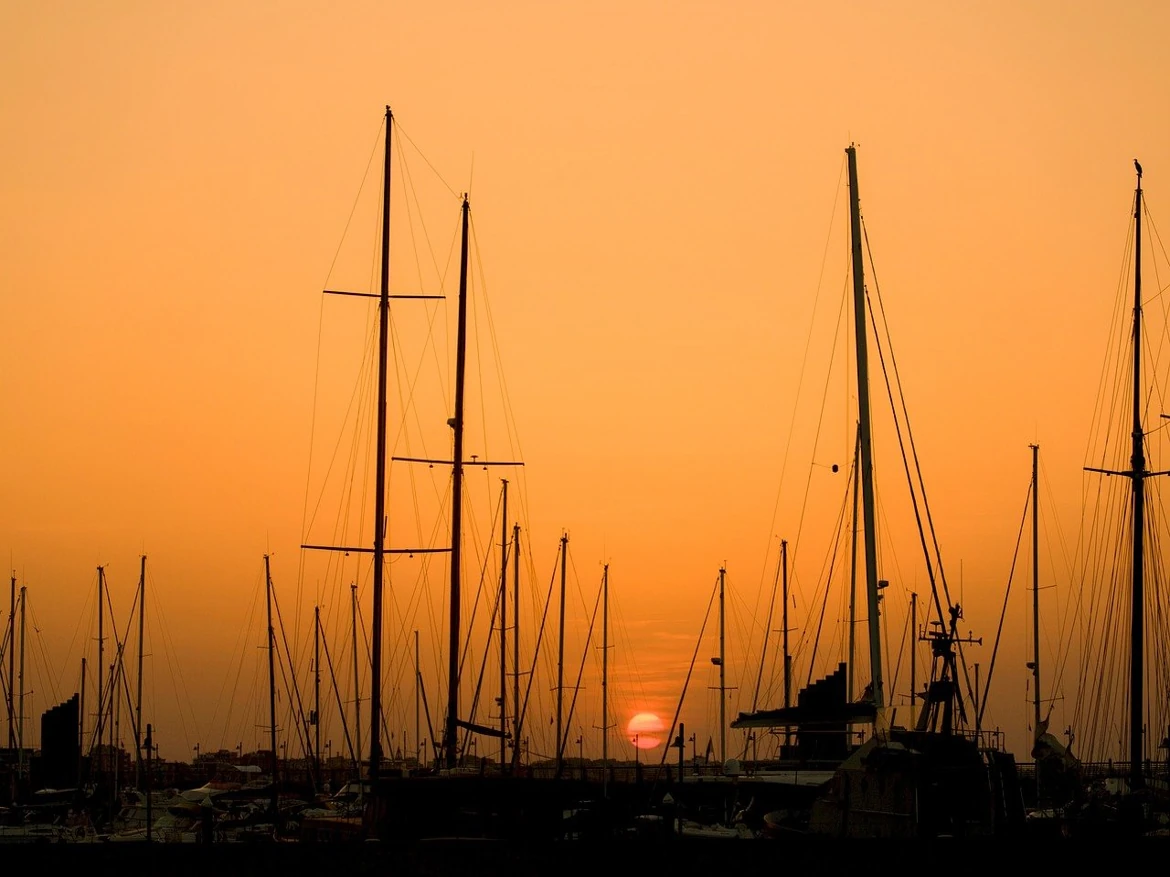 Sailboats at sunset with orange sky