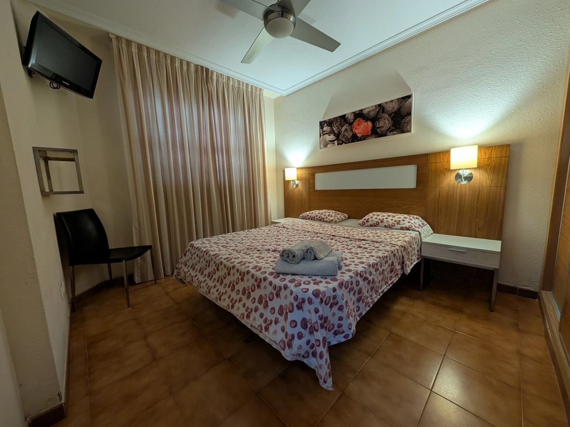 Cozy hotel room with double bed and decor.