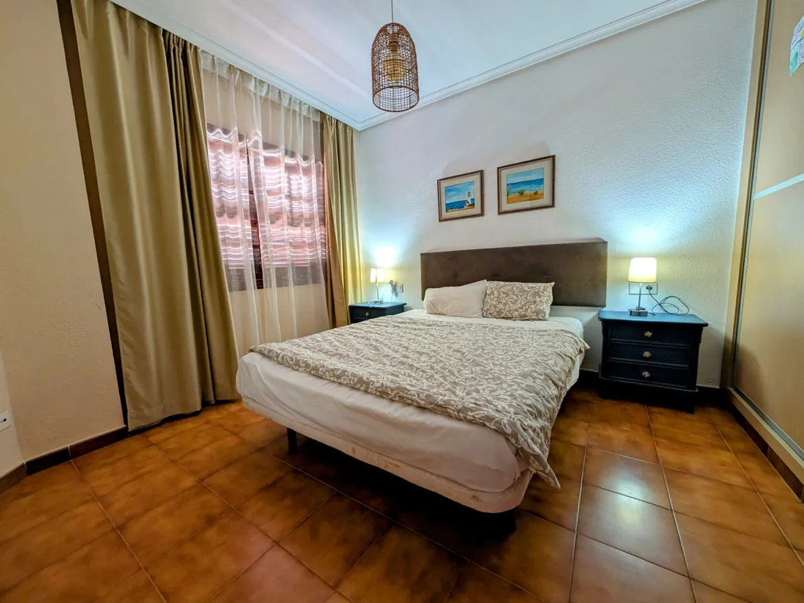 Cozy bedroom with double bed and warm decor.