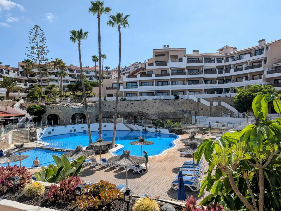 Resort with outdoor pool and sun loungers.