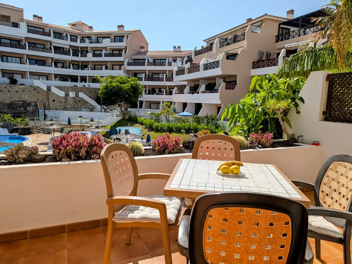 Cozy balcony view of apartment complex and garden.